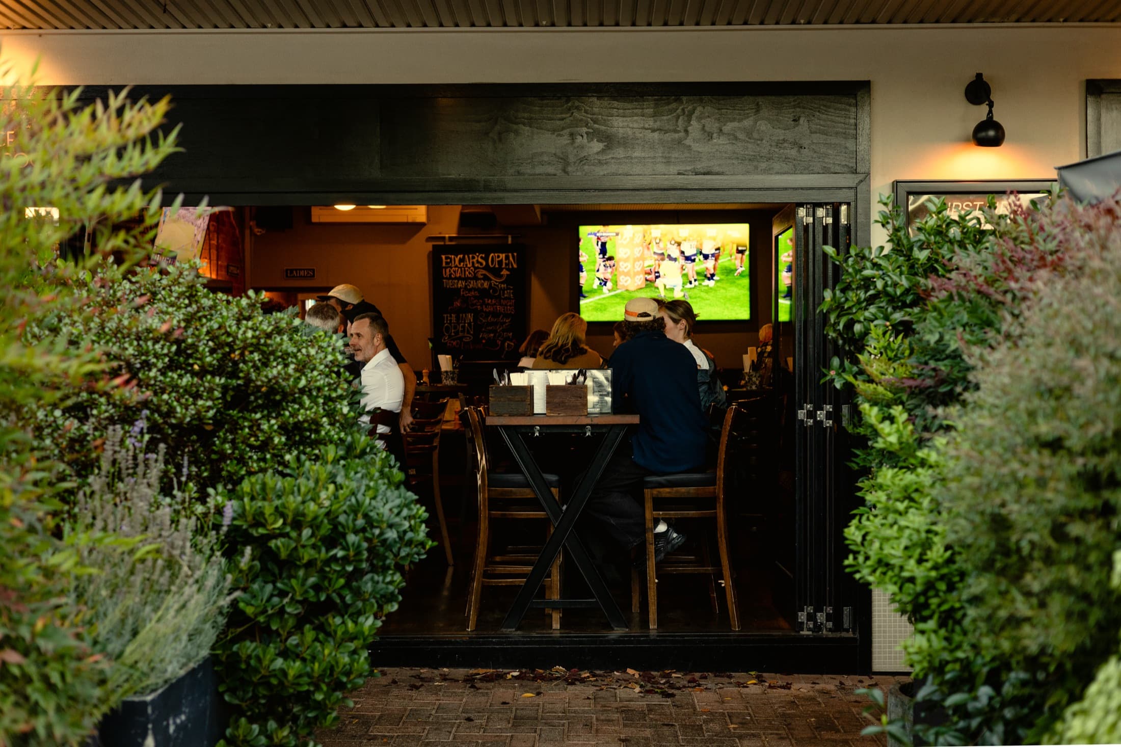 Inside Edgar's: locals at high tables with the footy on