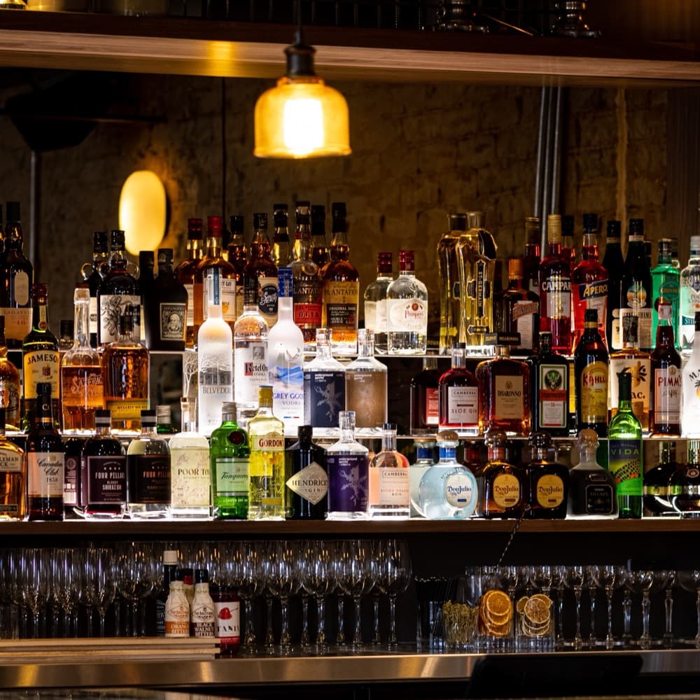Wakefield's back bar, bottles lit under a pendant
